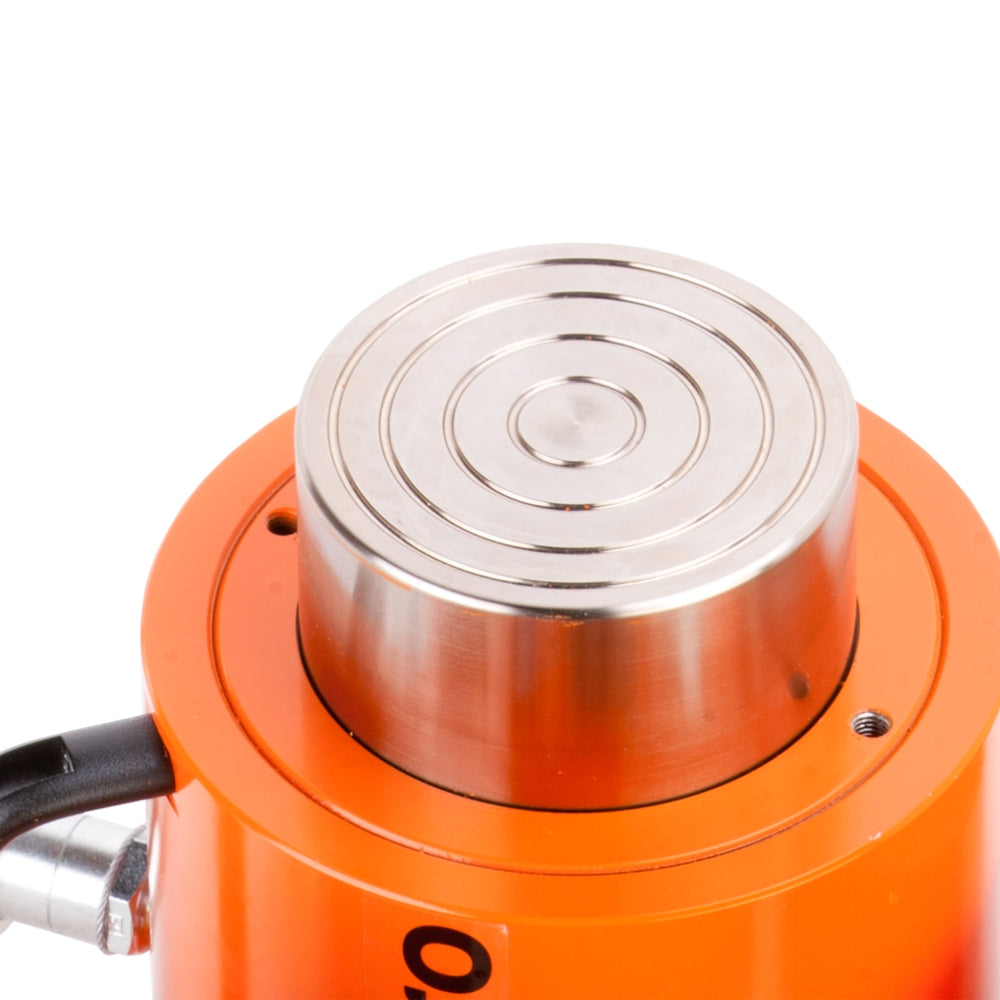 Orange hydraulisk donkraft med koncentriske cirkler på toppladen og sort håndtag.